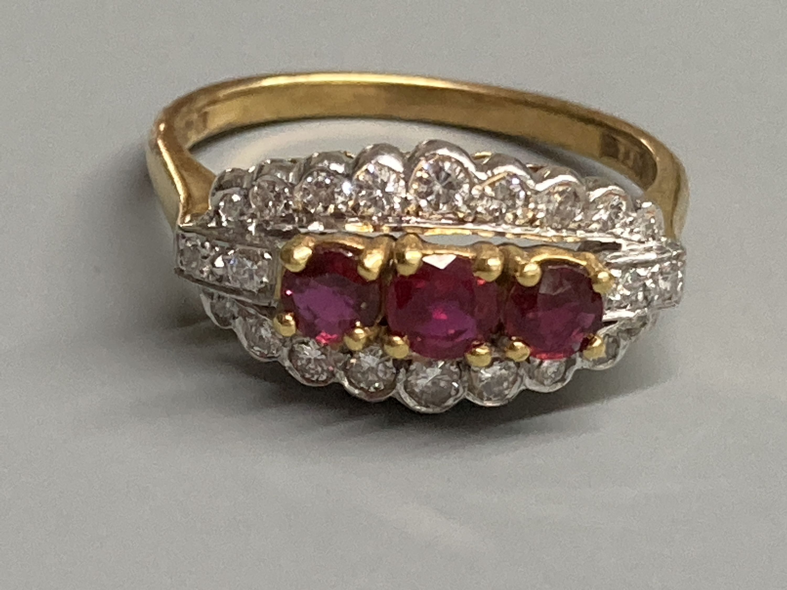 A modern 18ct gold, ruby and diamond set ovoid cluster ring, size M, gross 4.4 grams.